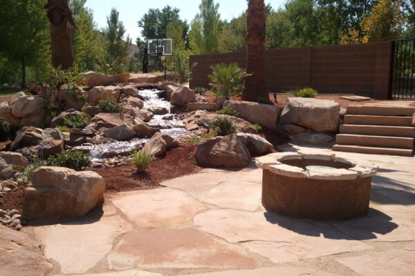 patio with fire pit and waterfall